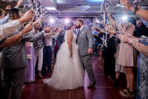 Wedding Day Photo of couple kissing in the crowd